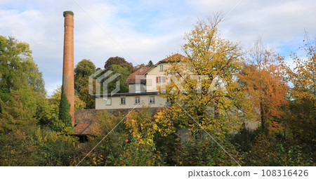 Old factory Schoenau surrounded by colorful trees. 108316426