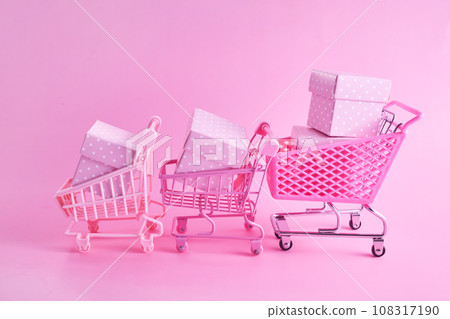 Pink friday concept. Online shopping.. Full shopping cart with presents. Pink friday concept. Online shopping.. Full shopping cart with presents. 108317190