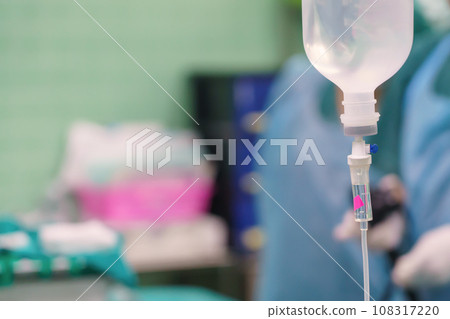 Normal saline solution or sodium chloride with infusion bottle drip for patient in hospital, Intravenous system of operating surgeons 108317220
