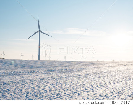 Wind turbines and agricultural field on winter day. Wind turbines and agricultural field on winter day. 108317917