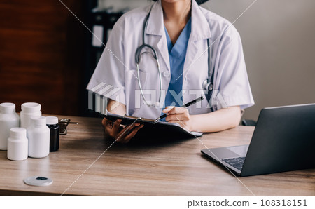 Medical technology concept. Doctor working with mobile phone and stethoscope in modern office Medical technology concept. Doctor working with mobile phone and stethoscope in modern office 108318151