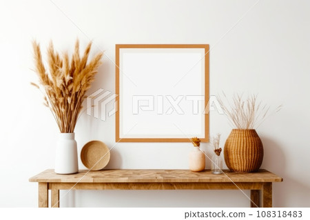 White frame mockup on the wall with wooden table and modern vase with dry herbs 108318483