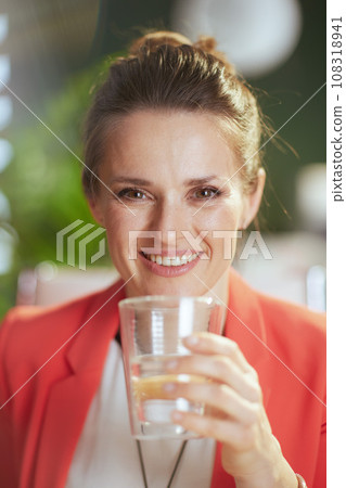 Portrait of happy business owner woman in green office Portrait of happy business owner woman in green office 108318941
