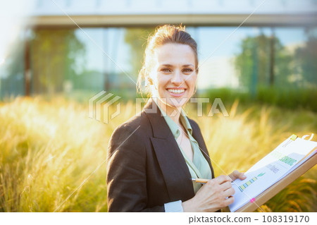 smiling 40 years old woman employee near business center smiling 40 years old woman employee near business center 108319170
