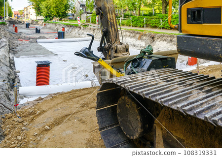 Use of geotextile fabric rolls for drainage and separation of base layers in street reconstruction 108319331
