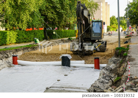 Use of geotextile fabric rolls for drainage and separation of base layers in street reconstruction 108319332