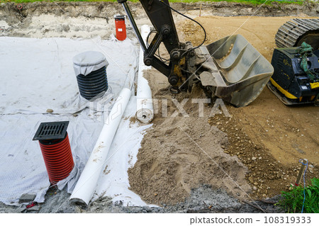 Use of geotextile fabric rolls for drainage and separation of base layers in street reconstruction 108319333