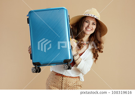 smiling housewife in blouse and shorts isolated on beige smiling housewife in blouse and shorts isolated on beige 108319616