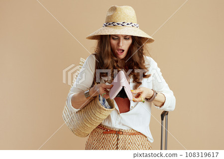 sad trendy female in white blouse and shorts isolated on beige sad trendy female in white blouse and shorts isolated on beige 108319617