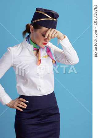 tired stylish flight attendant woman on blue 108319763