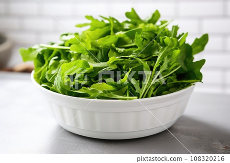 bright green salad leaves in a white ceramic bowl 108320216