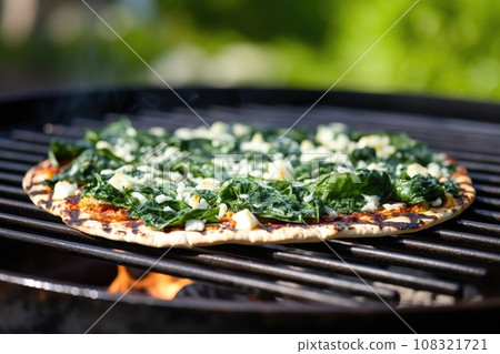grilled pizza with spinach and feta cheese on bbq grilled pizza with spinach and feta cheese on bbq 108321721