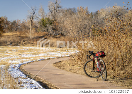 touring gravel bike at on a biking trail in Fort Collins, Colorado in fall scenery with some snow and dried sunflowers 108322937