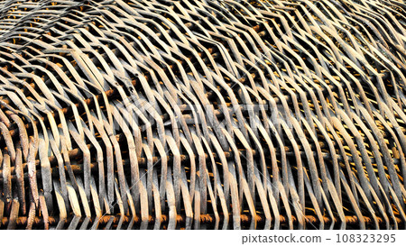 Fragment of textured braided surface made of beach umbrella rods Fragment of textured braided surface made of beach umbrella rods 108323295