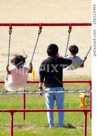 play on the swing in the park 108323404