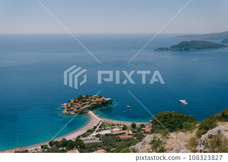 Isthmus of the island of Sveti Stefan with a beach. Montenegro Isthmus of the island of Sveti Stefan with a beach. Montenegro 108323827