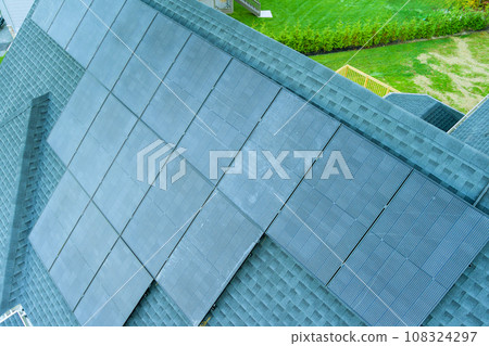 An installation of solar panels on roof of house 108324297