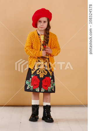 little model girl in designer dress, red hat and military boots full body photo walking little model girl in designer dress, red hat and military boots full body photo walking 108324578