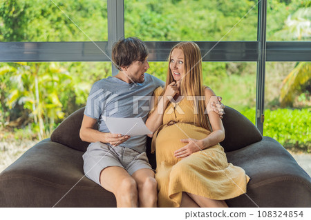 Cost of Pregnancy And Family Budgeting Concept. Young couple expecting baby, planning budget and counting spends at home Cost of Pregnancy And Family Budgeting Concept. Young couple expecting baby, planning budget and counting spends at home 108324854