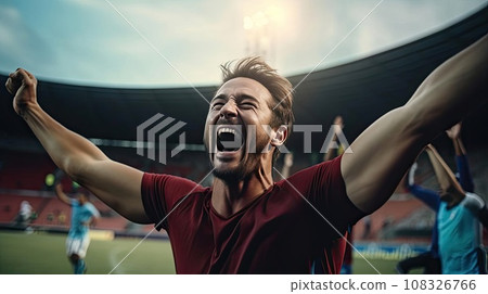 Happy man raising his hands in the air at a football game Happy man raising his hands in the air at a football game 108326766