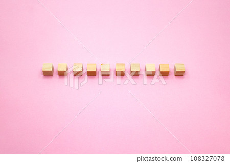Pink background of 10 three-dimensional wood cubes Pink background of 10 three-dimensional wood cubes 108327078