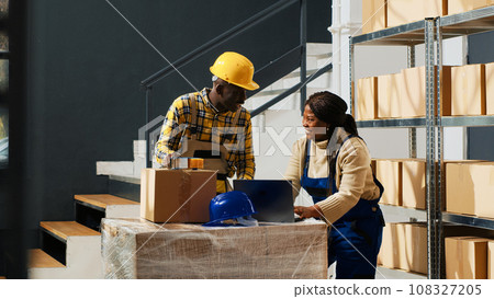 Happy group of employees laughing and checking boxes, preparing products in packages for shipment and distribution. Young people having fun at work in warehouse, stock supplies. Tripod shot. Happy group of employees laughing and checking boxes, preparing products in packages for shipment and distribution. Young people having fun at work in warehouse, stock supplies. Tripod shot. 108327205