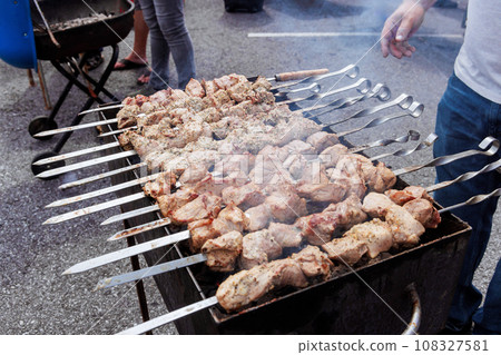 Traditional Turkish kebab on hot burning grill with skewers outdoors cooking 108327581