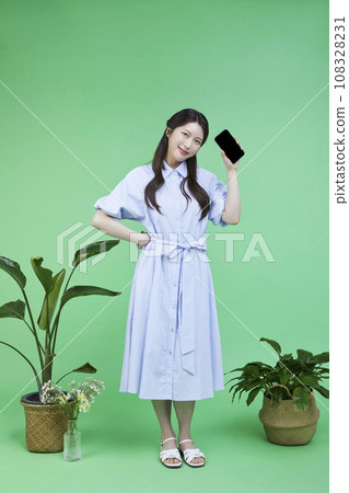 Quick Checkout_Picture of a korean asain beautiful woman posing with a smartphone image 108328231