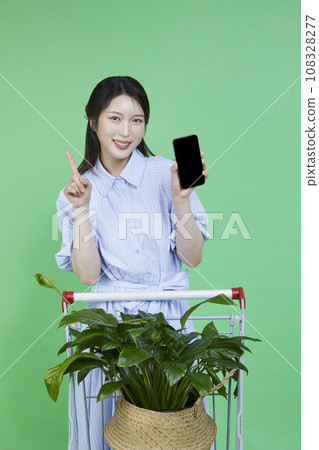 Greensumer_Shopping card with potted plants Image of a korean asain beautiful woman holding a smartphone. 108328277
