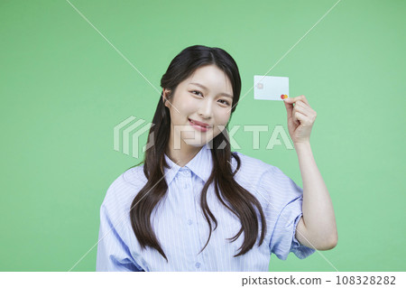 Easy checkout_Picture of a korean asain beautiful woman holding a recycled credit card image 108328282