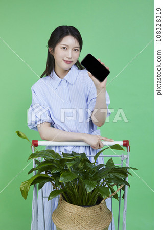 Greensumer_Shopping card with potted plants Image of a korean asain beautiful woman holding a smartphone. 108328319