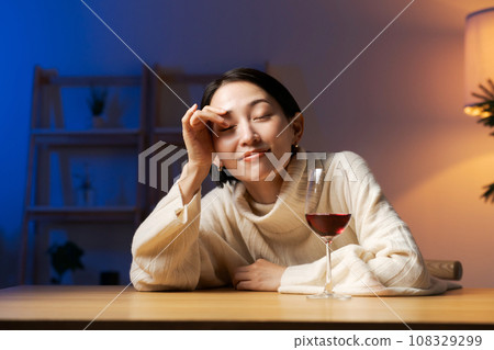 A woman drinking wine A woman drinking wine 108329299