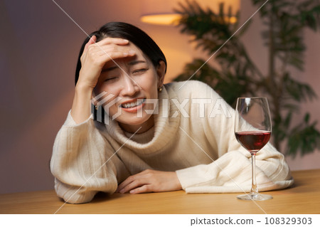 A woman drinking wine A woman drinking wine 108329303