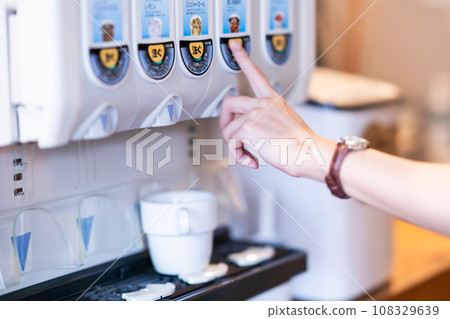 Young woman taking a break at a drink bar, faceless 108329639