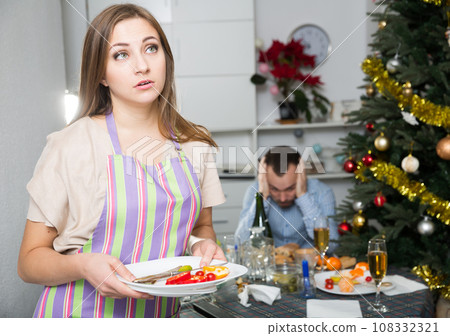 Woman cleaning table after dinner 108332321