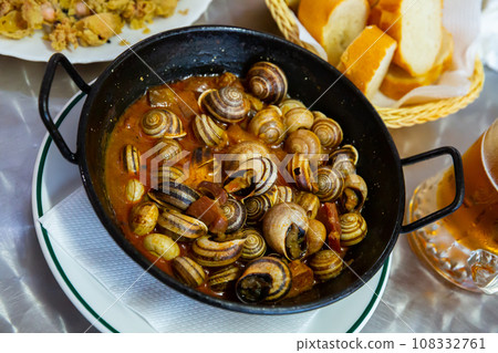 Grape snails in sauce. Spanish dish 108332761