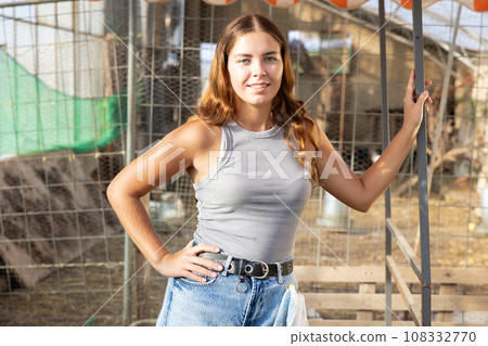 Young woman posing at chicken farm 108332770