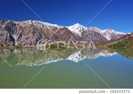 Beautiful Happo Pond reflecting the Hakuba Mountain Range 108333373