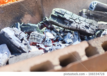 Burnt charcoal lined up on a bonfire stand Burnt charcoal lined up on a bonfire stand 108334728