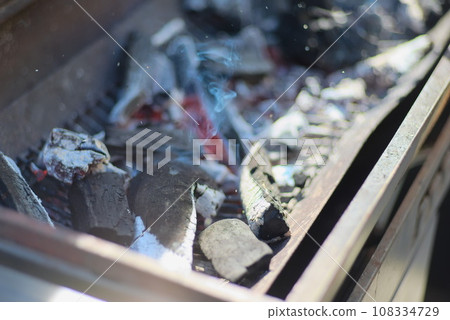 Burnt charcoal lined up on a bonfire stand Burnt charcoal lined up on a bonfire stand 108334729