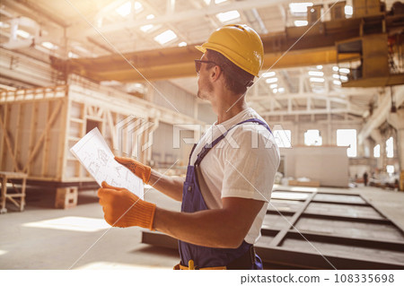 Architect working at house building construction site with blueprint Architect working at house building construction site with blueprint 108335698