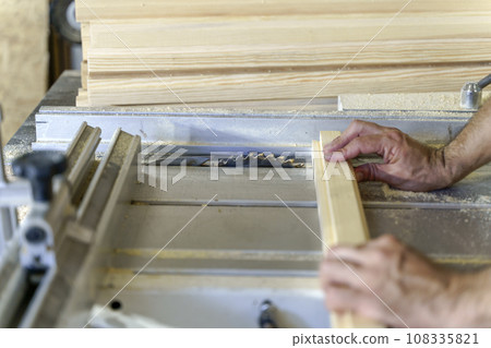A carpenter working with wood in a carpentry workshop. Furniture manufacture A carpenter working with wood in a carpentry workshop. Furniture manufacture 108335821