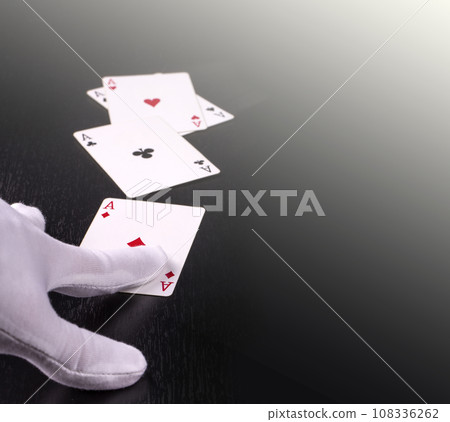 hand of the dealer in white gloves in a casino handing out cards 108336262
