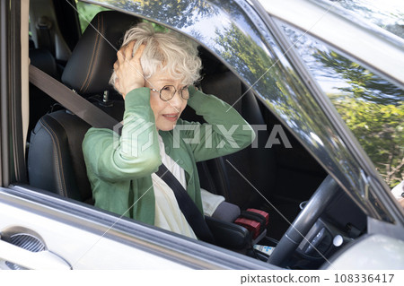 Senior woman having trouble while driving 108336417