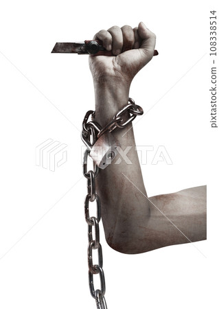 The hand of a scary zombie with blood and wounds holding a knife while tied to the iron chain 108338514