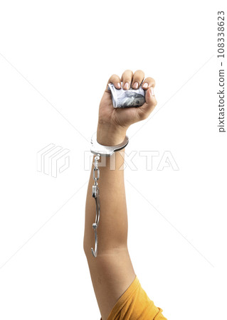 A human hand in handcuff holding money A human hand in handcuff holding money 108338623