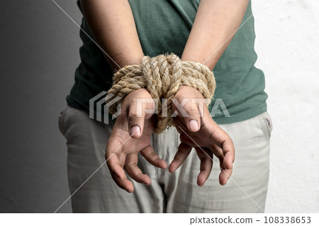 The man's hands are tied by rope 108338653