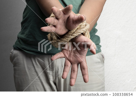 The man's hands are tied by rope 108338654