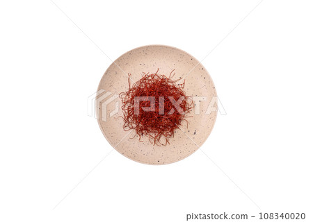 Red thin hot chili threads on a dark background 108340020