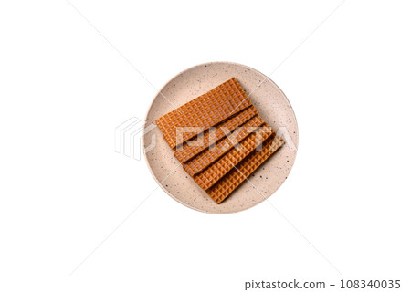 Delicious sweet crispy rectangular waffles on a ceramic plate 108340035